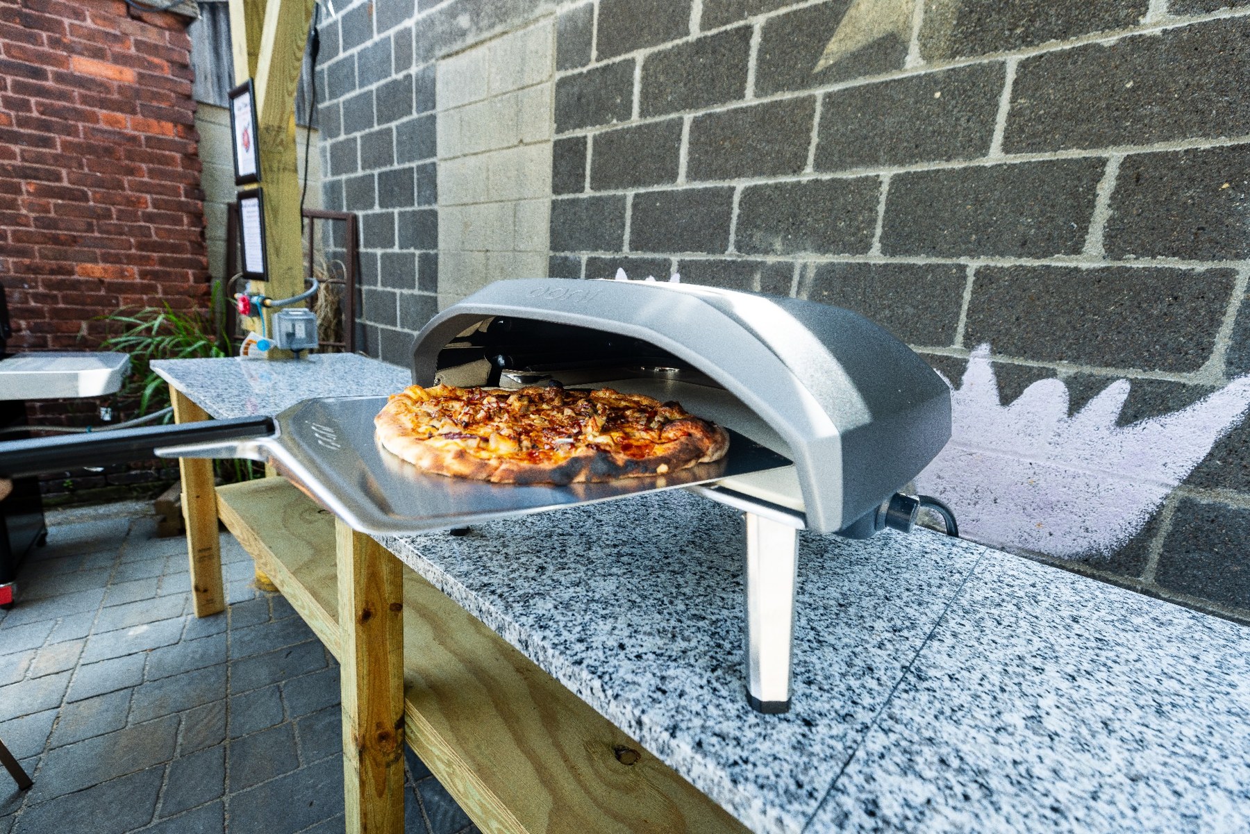 Pizza cooking in the outdoor pizza oven